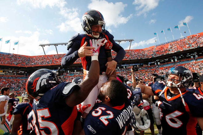 Denver Broncos kicker Matt Prater is held up by teammates after kicking the winning field goal during overtime of an NFL football game against the Miami Dolphins, Sunday, Oct. 23, 2011 in Miami. The Broncos won 18-15. (AP Photo/Wilfredo Lee)