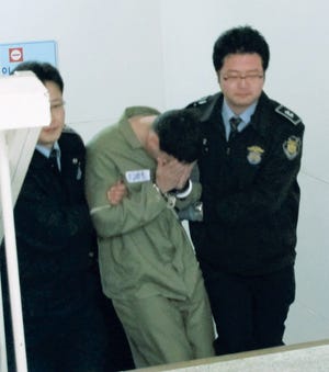 Army Pfc. Kevin Flippin leaves the Uijeongbu courthouse in South Korea after the first day of his trial Friday. Flippin confessed to assaulting a 17-year-old South Korean girl after a night of drinking Sept. 24.