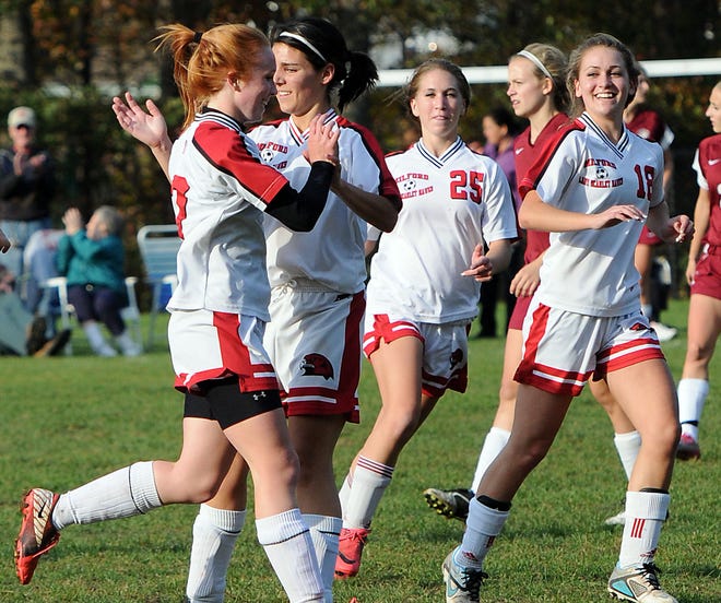 Milford's Olivia Grose (left) is celebrates with her teammates after scoring early in the Scarlet Hawks' 2-0 win over Westborough.