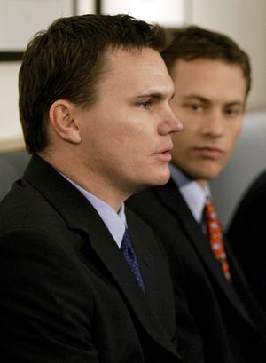 This Dec.12, 2005, file photo, shows Boston Red Sox co-general manager Ben Cherington, left, and co-general manager Jed Hoyer, right, during their three month tenure as shared general manager during a news conference at Fenway Park in Boston. Cherington is expected to be promoted today when the Red Sox have scheduled a news conference to introduce Theo Epstein's replacement. Epstein resigned from Boston to take over as president of baseball operations for the Chicago Cubs on Friday, and the teams said they would hold off on more announcements out of respect for the teams in the World Series; Today is an off-day.