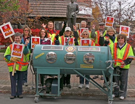 Rotary International has lead a campaign to eradicate polio throughout the world. As part of a nationwide awareness campaign, the local Rotary clubs pushed an actual iron lung for one mile through Sault Ste. Marie on Monday. Here, the group smiles at the corner of E. Spruce and Ashmun streets after their trek.