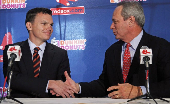 New Red Sox general manager Ben Cherington (left) shakes hands with team president Larry Lucchino during a news conference to announce Cherington as Boston's replacement for Theo Epstein.