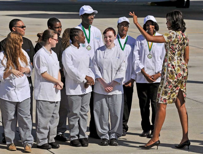 Will.Dickey@jacksonville.com--10/27/11--First Lady Michelle Obama waves to culinary art students after he plane landed at Jacksonville Naval Air Station Thursday, October 24, 2011 in Jacksonville, Florida. (The Florida Times-Union, Will Dickey)