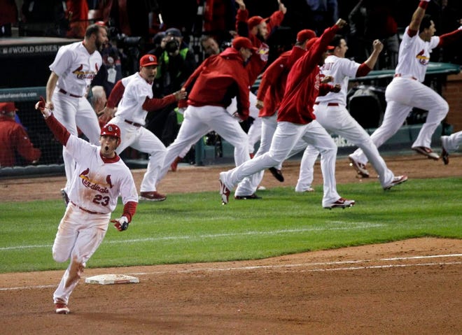 St. Louis Cardinals' David Freese reacts after hitting a solo home run off a pitch by Texas Rangers' Mark Lowe in the 11th inning of Game 6 of baseball's World Series Thursday, Oct. 27, 2011, in St. Louis. The Cardinals won 10-9. (The Associated Press)