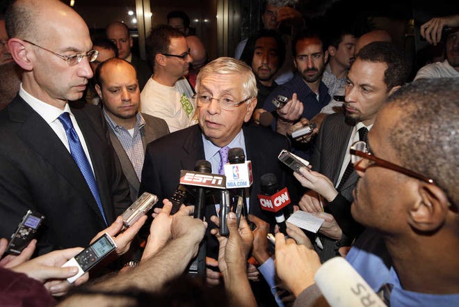 NBA Commissioner David Stern talks to reporters as he leaves the NBA labor talks Monday, Oct. 10, 2011, in New York. Stern canceled the first two weeks of the season Monday after players and owners were unable to reach a new labor deal to end the lockout. "The gap is so significant that we just can't bridge it at this time," said Stern, who added it's doubtful a full 82-game season can be played. At left is Deputy Commissioner Adam Silver. (AP Photo/David Karp)