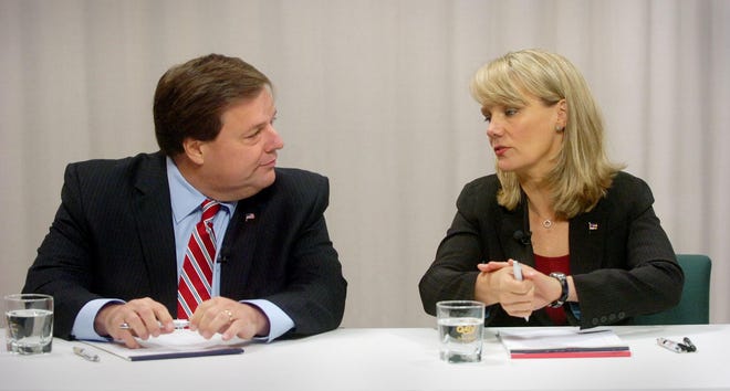 Quincy Mayor Thomas Koch and challenger Anne Mahoney chat before the start of their debate, televised live from the QATV studios, Thursday, Oct. 27, 2011.
