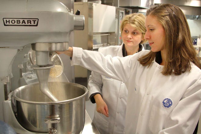 Vanessa Klimczak, foreground, and Susan Kay work in the Bay State Milling test kitchen on Thursday, Oct. 27, 2011.