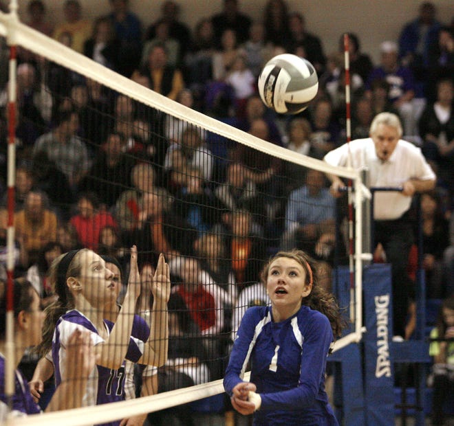 Jackson’s Linsey Grzeschik (left) watches Lake's Brooke Baldwin bump the ball to a teammate during Thursday’s district championship game at Lake High School. The Polar Bears won in three sets to earn their second straight regional berth.