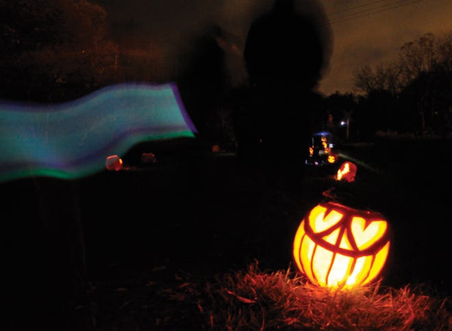 The annual Jack-O-Lantern display in Victor hosts ghostly pumpkin carvings along a local walking trail.