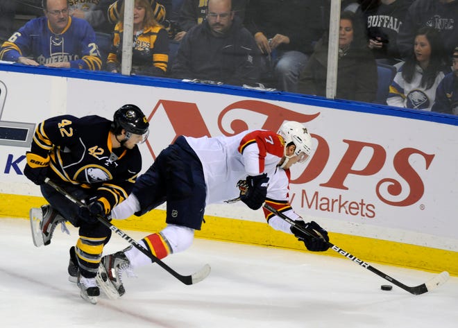 Buffalo Sabres' Nathan Gerbe (42) trips up Florida Panthers' Dmitry Kulikov, (7), Russia, during the third period of an NHL hockey game in Buffalo, N.Y., Saturday, Oct. 29, 2011. The Panthers defeated the Sabres 3-2. (AP Photo/Dan Cappellazzo)