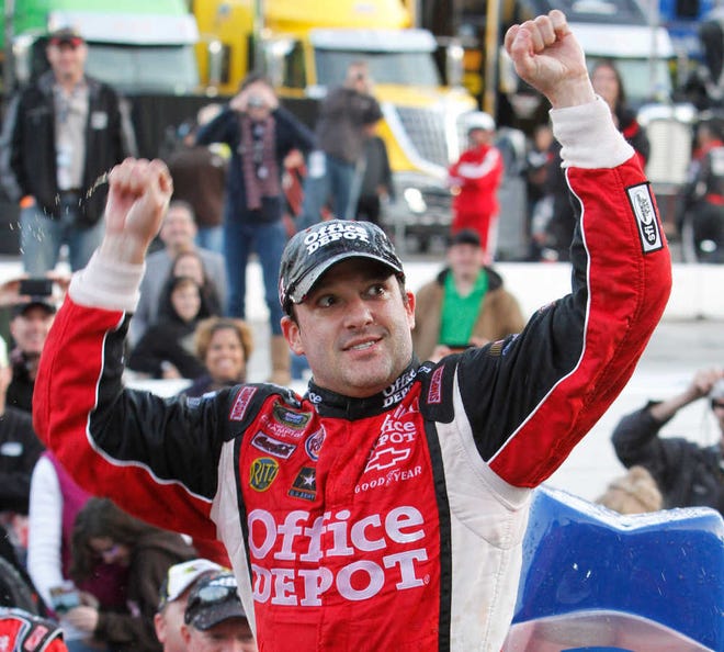 Tony Stewart celebrates his win in the NASCAR Sprint Cup Series auto race at Martinsville Speedway in Martinsville, Va., Sunday, Oct. 30, 2011. (AP Photo/Steve Helber)
