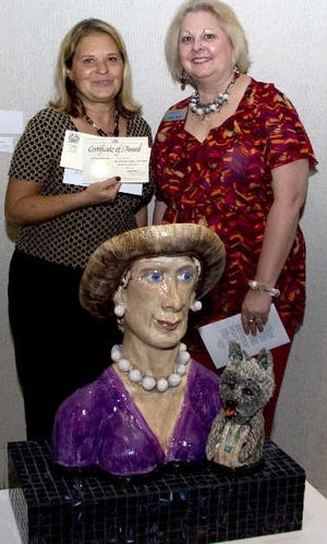 Diane Shepherd, left, with Mary Cay Brock, Community First Credit Union event sponsor. In front is Shepherd's award-winning entry, "Esmerelda & Her Little Dog."