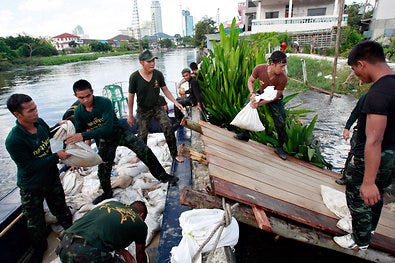 Thai soldiers place sandbags to fortify a breach in one of Bangkok's floodwalls on Sunday.