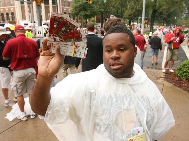 Licensed ticket seller Jerry Stanley Siler Jr. displays his tickets for sale on the corner of University Boulevard and Colonial Drive on the University of Alabama campus in Tuscaloosa in 2009. Tickets for the UA-LSU game on Saturday are selling for much more than other college football games.