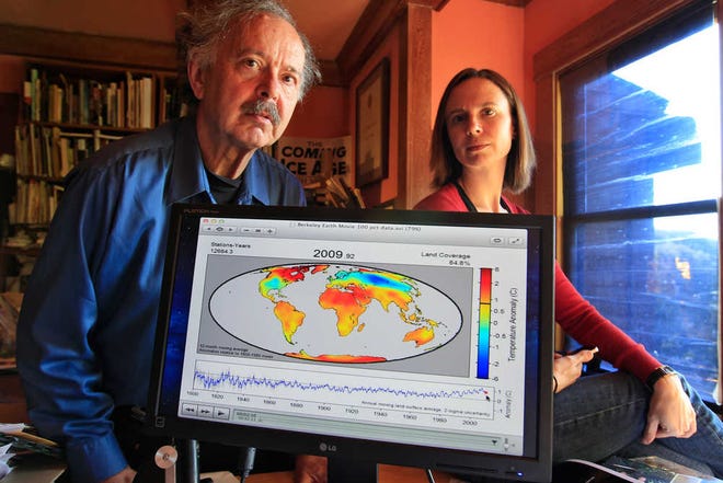 In this Friday, Oct. 28, 2011 photo, Richard Muller, left, and his daughter, Elizabeth Muller, right, pose with a map from their study on climate at their home in Berkeley, Calif. A new study of Earth's temperatures going back more than 200 years finds the same old story: It's gotten hotter in the last 60 years. What's different is the scientist behind the latest study, Richard Muller. The California physicist was doubtful of what climate scientists have been saying - until he did his own research, partly funded by climate change skeptics. Elizabeth Muller, co-founder and executive director of the Berkeley Earth Surface Temperature Study, ran the study. (AP Photo/Paul Sakuma)