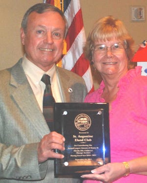 Eland president Linda Rittenhouse receives award from Ben Brown, director, Florida Elks Mobile Van Therapy Service