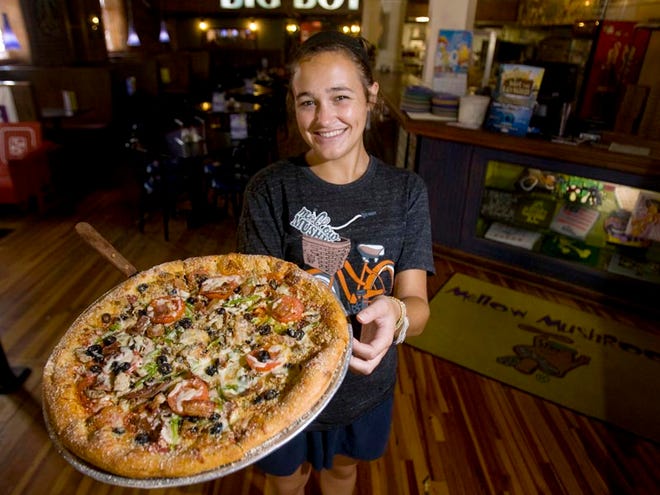 Sara Beth Wint, a server at Mellow Mushroom in downtown Tuscaloosa, Ala., displays a "House Pizza". Mellow Mushroom was voted "Best Pizza" in the Best of Tuscaloosa.