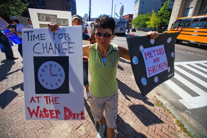 Brockton homeowner Marianne Silvacomes takes part in the Brockton Water Party on Monday afternoon at City Hall to protest what she and other residents call inaccurate and exorbitant water bills.
