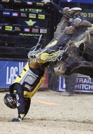 Mike Lee is thrown from Spit Fire during the final round of PBR
World Finals rodeo Sunday in Las Vegas. The five-day event drew
70,000 spectators.