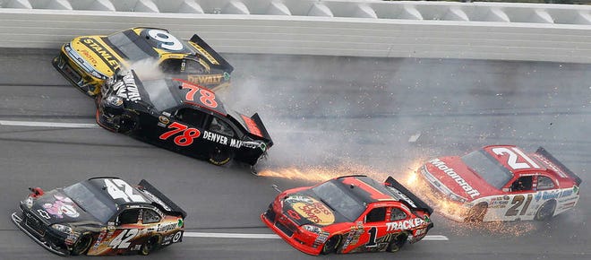 Regan Smith (78) collides with Marcos Ambrose (9) as Juan Pablo Montoya (42) Jamie McMurray (1) and Trevor Bayne (21) go low during the NASCAR Sprint Cup Series auto race at Talladega Superspeedway on Sunday, Oct. 23, 2011, in Talladega, Ala. (AP Photo/Butch Dill)