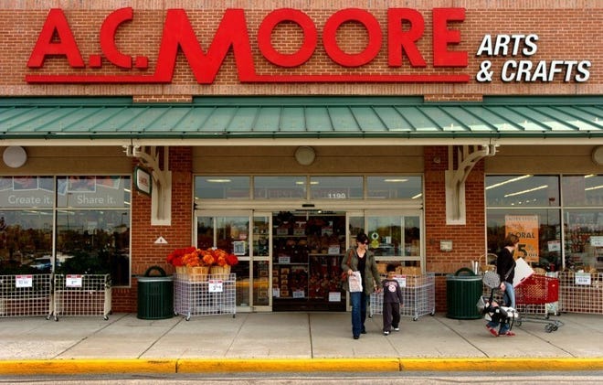 Customers leave the A.C. Moore store in the East Gate shopping
Center in Moorestown. The board of directors is advising
shareholders to vote in favor of a merger with a local crafts
distributor.