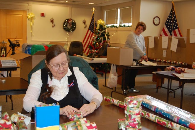 Abington resident Sandra Temple was one of the people who volunteered to help wrap presents to be sent to Abington troops stationed overseas last year.