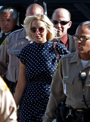 Actress Lindsay Lohan arrives for a probation hearing at Los Angeles Superior Court Wednesday, Nov. 2, 2011. A city prosecutor is advocating the starlet be sent back to jail for her latest violation of a court order. She remains on probation for a 2007 drunken driving case and a misdemeanor theft case. (AP Photo/Reed Saxon)