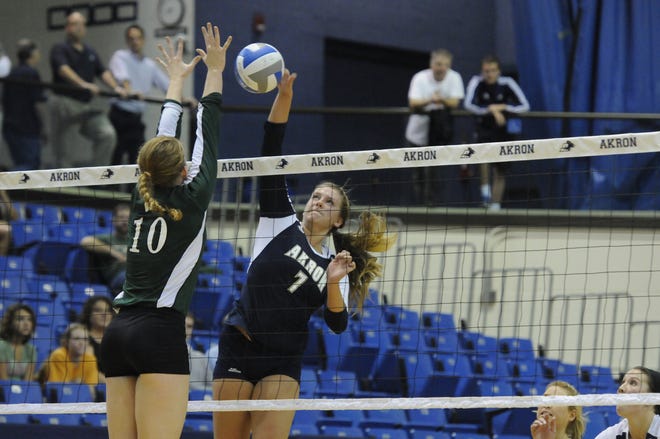 Canandaigua alumnus Kymberle Gordon goes up for a kill as a member of the University of Akron volleyball team.