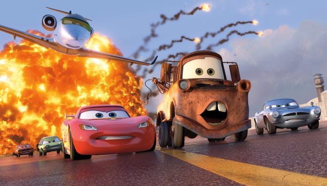 The animated characters Lightning McQueen, voiced by Owen Wilson, left, Mater, voiced by Larry the Cable Guy, and Finn McMissile, voiced by Michael Caine, right, are shown in a scene from "Cars 2."