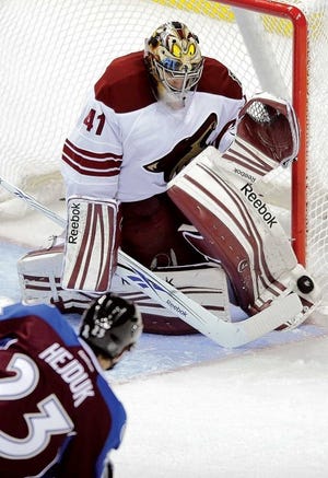 Coyotes goalie Mike Smith blocks a shot from Avalanche right
wing Milan Hejduk during Wednesday night's game in Denver.