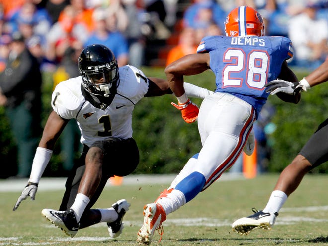 Florida Gators running back Jeff Demps (2) fakes out Vanderbilt Commodores safety Kenny Ladler (1) and runs for a touchdown during the second half at Ben Hill Griffin Stadium on Saturday, Nov. 5, 2011, in Gainesville, Fla. Florida defeated Vanderbilt 26-21.