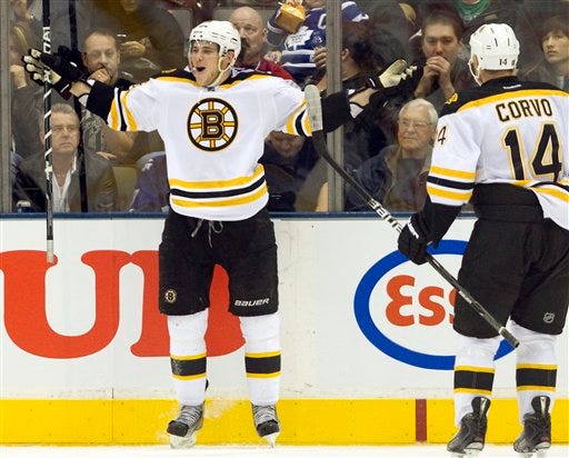 Boston Bruins center Tyler Seguin celebrates his third goal for a hat trick with teammate Joe Corvo during second-period NHL hockey game action against the Toronto Maple Leafs in Toronto, Saturday, Nov. 5, 2011. (AP Photo/The Canadian Press, Frank Gunn)