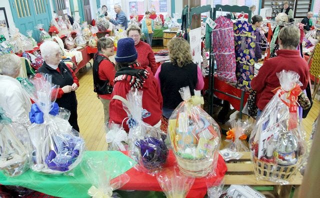Shoppers browse items for sale at the First Church Congregational Winter Faire in Rochester Saturday.
EJ Hersom/Staff photographer