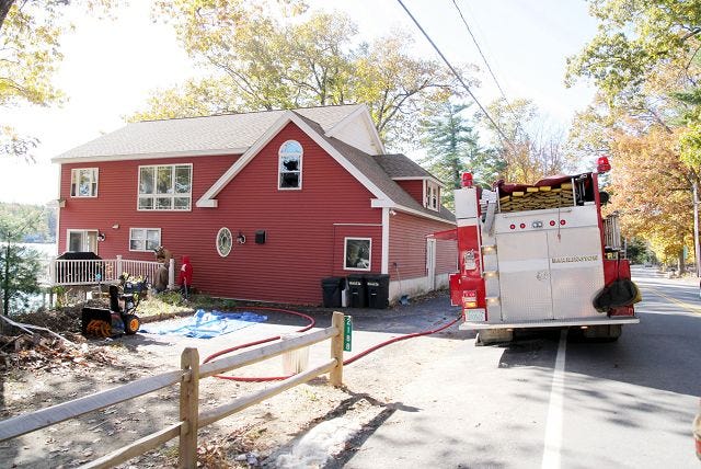 EJ Hersom/Staff photographer A fire truck sits outside a Barrington home after firefighters extinguished a fire at the residence on Route 9 Saturday.