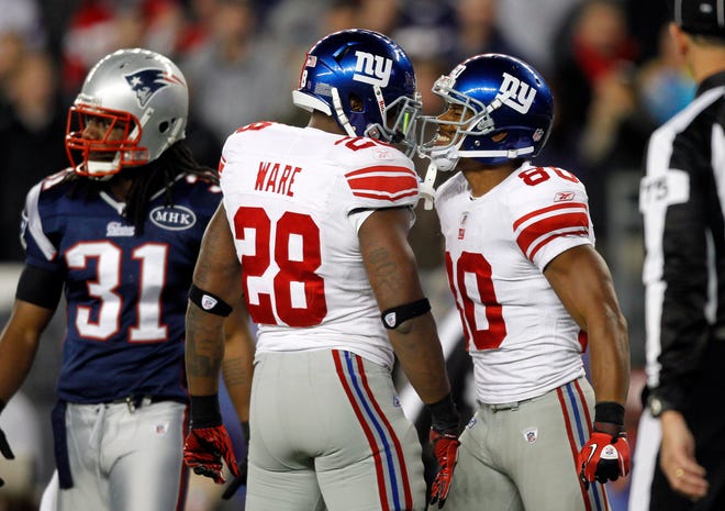 Giants wide receiver Victor Cruz (80) and D.J. Ware celebrate an interference call beside Patriots free safety Sergio Brown (31) in the fourth quarter of the Patriots' 24-20 loss on Sunday in Foxboro.