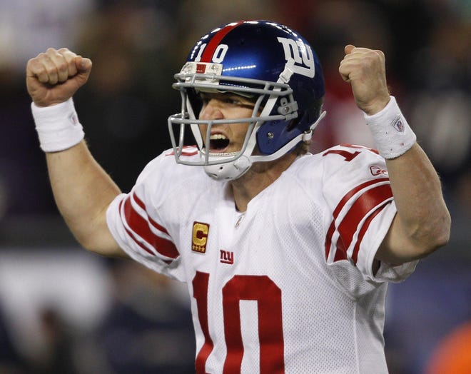 New York Giants quarterback Eli Manning celebrates his touchdown pass to tight end Jake Ballard in the last minute of an NFL football game in Foxborough, Mass., Sunday, Nov. 6, 2011. The Giants defeated the New England Patriots 24-20.