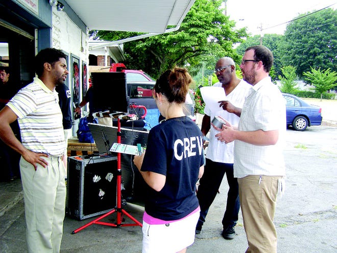Koran Dunbar chats with key personnel during a filming break this past summer in Greencastle. Tiffany Vinson as production coordinator works on scheduling, wardrobe and organizing extras. Quevaughn Bryant is an actor and professional comedian. Waylon K. Smith wrote comedy sketches with Dunbar in high school and has been a partner for years to bring ‘Greencastle’ to fruition.