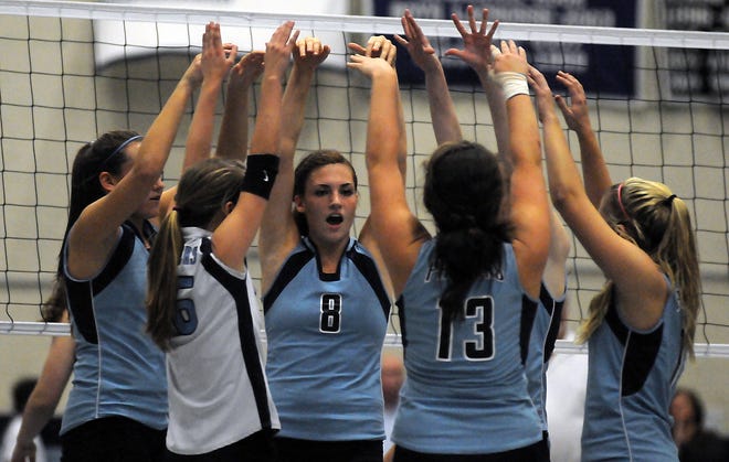 Franklin volleyball players celebrate after winning a point during their victory over Westford Academy.