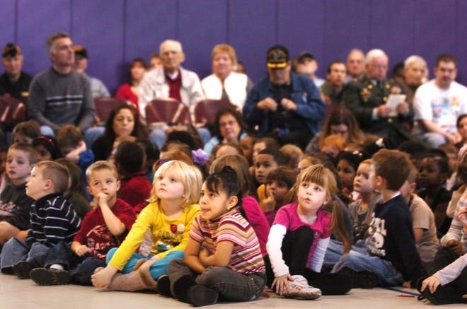 Children and veterans, and their guests listen, as Vet of the
Year for 2011 Jay Renwick of Maple Shade, says a few words at the
Veteran's Day celebration ceremony Wednesday, at Howard R. Yocum
School in Maple Shade.