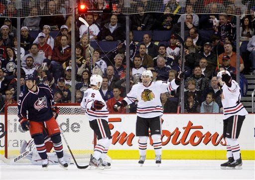 Chicago Blackhawks' Steve Montador (5) Andrew Brunette, second from right, and Marcus Kruger, right, of Sweden, celebrate their goal against the Columbus Blue Jackets during the second period of an NHL hockey game Thursday, Nov. 10, 2011, in Columbus, Ohio.