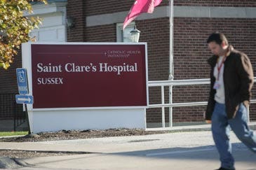 Photo by Daniel Freel/New Jersey Herald A hospital employee is seen walking outside Saint Clare’s Hospital in Sussex in a photo from November 2010.