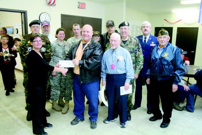 Kim LaHaie (left) of Straits Area Services presents a check to Mike Wise of Cheboygan County Veterans Services during a Veterans’ Day event at the SAS offices in Chedoygan on Friday. The $200 donation is to be allocated for the Veterans Assistance Fund.