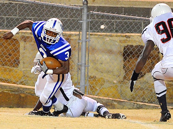 Etowah’s Devin Horton tries to break the tackle of a Center Point defender during the Class 5A second-round playoff game Friday night at Jim Glover Field in Attalla.