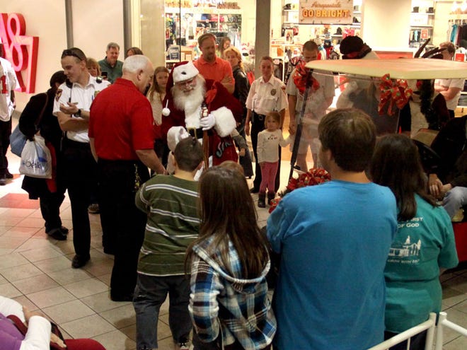 Santa arrives at the University Mall on Friday. St. Nick rode in a parade to the center of the mall, where he will stay until Christmas Eve.