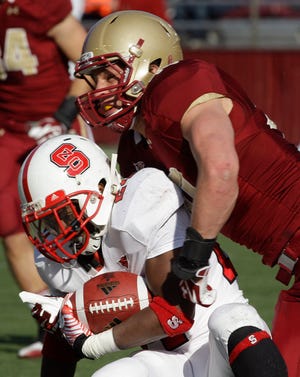 Boston College linebacker Luke Kuechly, right, tackles North Carolina State running back James Washington (24) during the first half of an NCAA college football game in Boston, Saturday, Nov. 12, 2011. (AP Photo/Stephan Savoia)