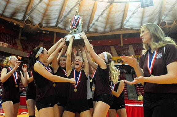 The Dakota Indians hold the 2011 IHSA Class 1A state championship trophy Saturday at Redbird Arena.