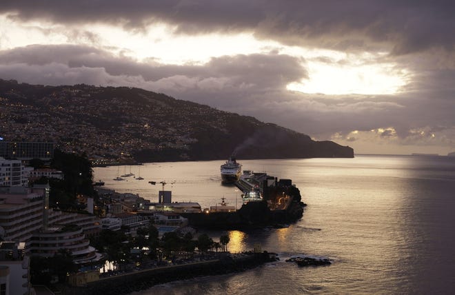 A cruise ship docks at sunrise in Funchal on the Portuguese island of Madeira. Madeira, a year-round resort, is a Portuguese archipelago located about 400 miles off the coast of north Africa and is known as the Pearl of the Atlantic. (AP Photo)