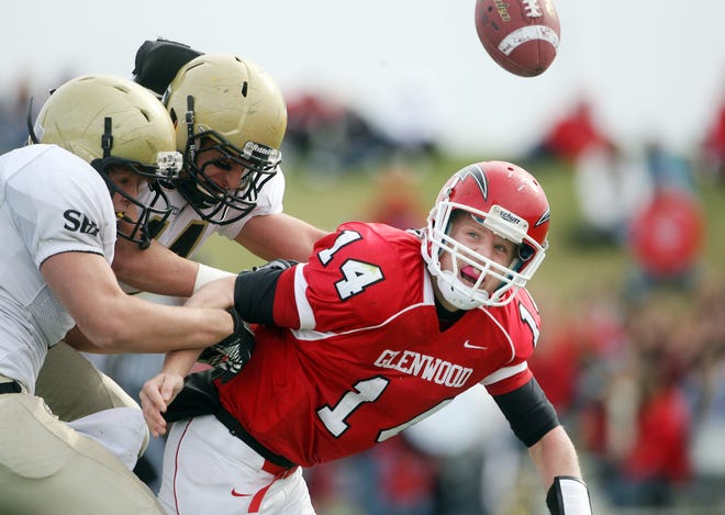 Glenwood quarterback Miles McAdams fumbles the ball under pressure from the Sacred Heart-Griffin defense at Chatham Glenwood Saturday, Nov. 12, 2011 in Chatham. The Titans recovered the ball.