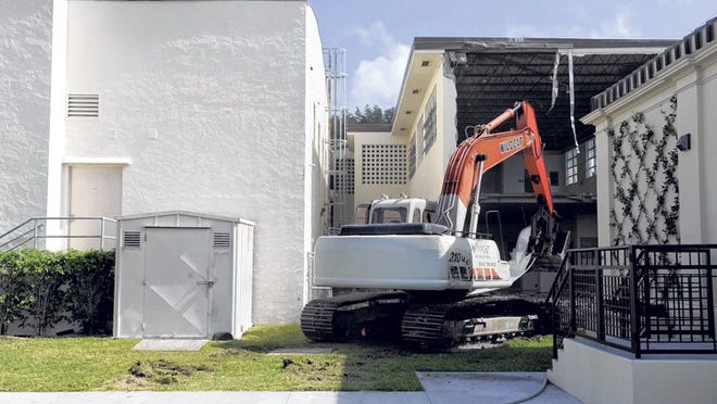 Crews from Wildcat Demoltion demolish part of the old Palm Beach Public school on Monday to make way for a new accessway to the Four Arts Complex.