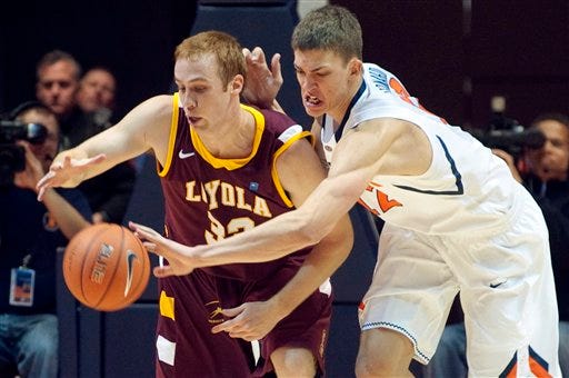Illinois' Meyers Leonard (12) knocks the ball away from Loyola's Walt Gibler (33) during the second half of an NCAA college basketball game, Friday, Nov. 11, 2011, in Champaign, Ill. Illinois won 67-49. (AP Photo/Robert K. O'Daniell)